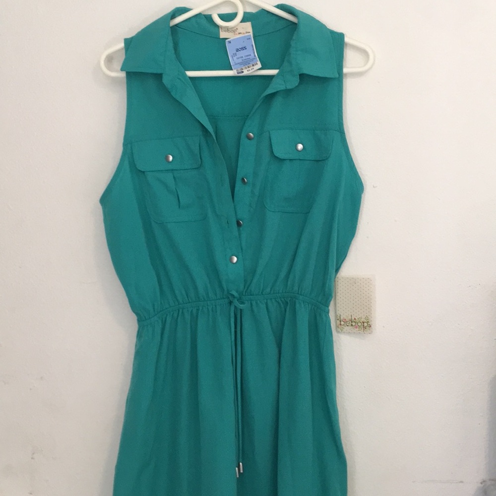 Turquoise blue dress with silver buttons.